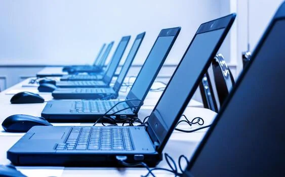 A row of laptops set up for online learning